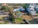 Aerial view showcases a backyard oasis with pool, patio, lush lawn, and waterfront access at 1479 Bay Point Dr, Sarasota, FL 34236