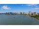 Beautiful city view of Sarasota waterfront with a skyline featuring luxury high-rise buildings against a clear blue sky with scattered clouds at 1479 Bay Point Dr, Sarasota, FL 34236