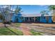 Charming blue home featuring a spacious front porch with brick steps, creating a welcoming entrance at 1479 Bay Point Dr, Sarasota, FL 34236