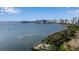 Scenic view of the bay with the city skyline and a bridge in the distance at 1479 Bay Point Dr, Sarasota, FL 34236