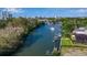 Scenic waterfront view features boat docks and a serene canal, with city skyline views in the background at 1479 Bay Point Dr, Sarasota, FL 34236