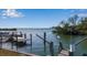 Waterfront view of a boat dock with a bridge and cityscape in the distance at 1479 Bay Point Dr, Sarasota, FL 34236