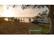 Serene waterfront scene featuring private boat docks with a scenic bench, trees and a calm bay in the background at 1479 Bay Point Dr, Sarasota, FL 34236