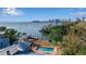 Aerial view of waterfront property with a pool, dock, and scenic views of the water and city at 1479 Bay Point Dr, Sarasota, FL 34236