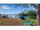 Waterfront property with a dock, boat lift, and scenic views of the water and bridge at 1479 Bay Point Dr, Sarasota, FL 34236