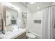 Bright bathroom with a tub, shower, modern sink, and stylish decorative tiles at 1490 Mahogany Ln # 706, Palm Harbor, FL 34683