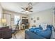 Spacious bedroom with a ceiling fan, television, and workout equipment, perfect for relaxing and staying active at 1490 Mahogany Ln # 706, Palm Harbor, FL 34683