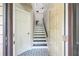 Inviting entryway showcasing black-and-white tile flooring and staircase leading to upper level at 1490 Mahogany Ln # 706, Palm Harbor, FL 34683