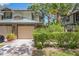 Charming townhome featuring a one-car garage, well-maintained landscaping, and inviting curb appeal at 1490 Mahogany Ln # 706, Palm Harbor, FL 34683