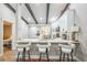 Kitchen pass-through with seating overlooking the dining area and white cabinetry at 1490 Mahogany Ln # 706, Palm Harbor, FL 34683