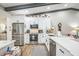 Bright kitchen features white cabinets, stainless steel appliances, and quartz countertops at 1490 Mahogany Ln # 706, Palm Harbor, FL 34683