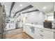 Open kitchen featuring stainless steel appliances, white cabinetry and breakfast bar at 1490 Mahogany Ln # 706, Palm Harbor, FL 34683