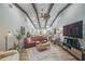 Open living area with vaulted ceiling, beams, and a seamless flow to the kitchen at 1490 Mahogany Ln # 706, Palm Harbor, FL 34683