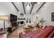 Comfortable living room featuring vaulted ceilings, fireplace, and sliding glass doors at 1490 Mahogany Ln # 706, Palm Harbor, FL 34683