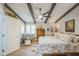 Spacious primary bedroom featuring exposed wood beams and wood-look flooring at 1490 Mahogany Ln # 706, Palm Harbor, FL 34683