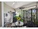 Cozy screened patio featuring decorative metalwork, comfortable seating and views of garden at 1490 Mahogany Ln # 706, Palm Harbor, FL 34683