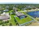 Aerial view of house with screened-in pool, large backyard, pond, set in lush residential neighborhood at 1603 21St W Ave, Palmetto, FL 34221