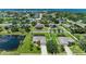 Beautiful aerial view of a well-maintained home with a screened-in pool, pond, and lush landscaping at 1603 21St W Ave, Palmetto, FL 34221