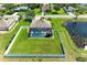 Aerial shot of home featuring fenced pool, pond views, and lush landscaping, set in residential area at 1603 21St W Ave, Palmetto, FL 34221