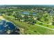 An overhead view of a naturalized green space with a large pond and green space for recreation at 1603 21St W Ave, Palmetto, FL 34221