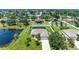 Aerial view of home with screened-in pool, large backyard, and pond, nestled in a residential community at 1603 21St W Ave, Palmetto, FL 34221