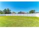 A large backyard with green grass surrounded by a white privacy fence offers a secluded outdoor space at 1603 21St W Ave, Palmetto, FL 34221