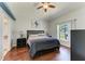 Cozy bedroom with a queen bed, ceiling fan, and view of the pool through the window at 1603 21St W Ave, Palmetto, FL 34221