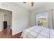 Bedroom with wood floors and a view of the green lawn through the window at 1603 21St W Ave, Palmetto, FL 34221