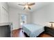 Bright bedroom with ceiling fan, wood floors, and a sunny window view to the screened lanai at 1603 21St W Ave, Palmetto, FL 34221