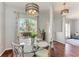 Dining room with a glass table set in front of a large window and view of the yard at 1603 21St W Ave, Palmetto, FL 34221