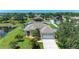 Beautiful single-story home with a well-manicured lawn and mature tropical landscaping and a two car garage at 1603 21St W Ave, Palmetto, FL 34221