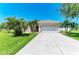 Lovely one story home with green lawn and tropical landscaping; garage with decorative windows at 1603 21St W Ave, Palmetto, FL 34221