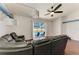 Open living room with sliding glass doors to the pool, hardwood floors, and leather sofas at 1603 21St W Ave, Palmetto, FL 34221