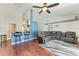 Spacious living room features a ceiling fan, hardwood floors, and a comfortable grey leather sofa at 1603 21St W Ave, Palmetto, FL 34221