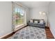 Cozy living room featuring a large window with backyard views, stylish curtains, and a modern gray sofa at 1603 21St W Ave, Palmetto, FL 34221