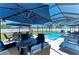 Relaxing pool area with ample seating, shade umbrellas and an outdoor grill at 1603 21St W Ave, Palmetto, FL 34221