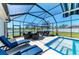 Covered pool with deck furniture and view of pond at 1603 21St W Ave, Palmetto, FL 34221