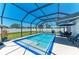 Screened-in pool with shaded patio and seating at 1603 21St W Ave, Palmetto, FL 34221