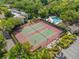 Aerial view of tennis courts, swimming pool and lush, tropical landscaping at 1621 Boathouse Cir # 125, Sarasota, FL 34231