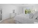 Bright bedroom boasts white walls, light wood floors, and sliding doors to a patio at 1621 Boathouse Cir # 125, Sarasota, FL 34231