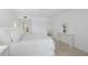 Bedroom with white walls and flooring offers a view of the Primary bathroom at 1621 Boathouse Cir # 125, Sarasota, FL 34231