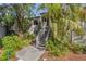 Charming townhome with wood stairs, lush landscaping and mature palm trees at 1621 Boathouse Cir # 125, Sarasota, FL 34231