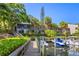 Exterior view showcases the condo building, dock, harbor, and lush tropical landscaping at 1621 Boathouse Cir # 125, Sarasota, FL 34231