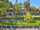 Charming waterfront condo complex with boat docks and outdoor seating, framed by lush greenery and trees at 1621 Boathouse Cir # 125, Sarasota, FL 34231