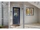 Close-up of front door and windows with a tile porch, offering a welcoming entrance to the home at 1621 Boathouse Cir # 125, Sarasota, FL 34231