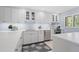 Bright kitchen featuring white cabinets, modern stainless steel appliances, and ample counter space at 1621 Boathouse Cir # 125, Sarasota, FL 34231
