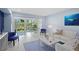 Inviting living room showcases light blue walls, and sliding glass doors to an outdoor deck at 1621 Boathouse Cir # 125, Sarasota, FL 34231