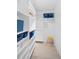 Bright walk-in closet with custom shelving, drawers, and a stool for easy organization at 1621 Boathouse Cir # 125, Sarasota, FL 34231