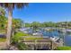 Scenic waterfront view of a marina with boats docked, accessible via a charming wooden walkway and stairs at 1621 Boathouse Cir # 125, Sarasota, FL 34231