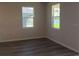 Light filled bedroom with dual windows offering tranquil views at 17041 James Trl, Parrish, FL 34219